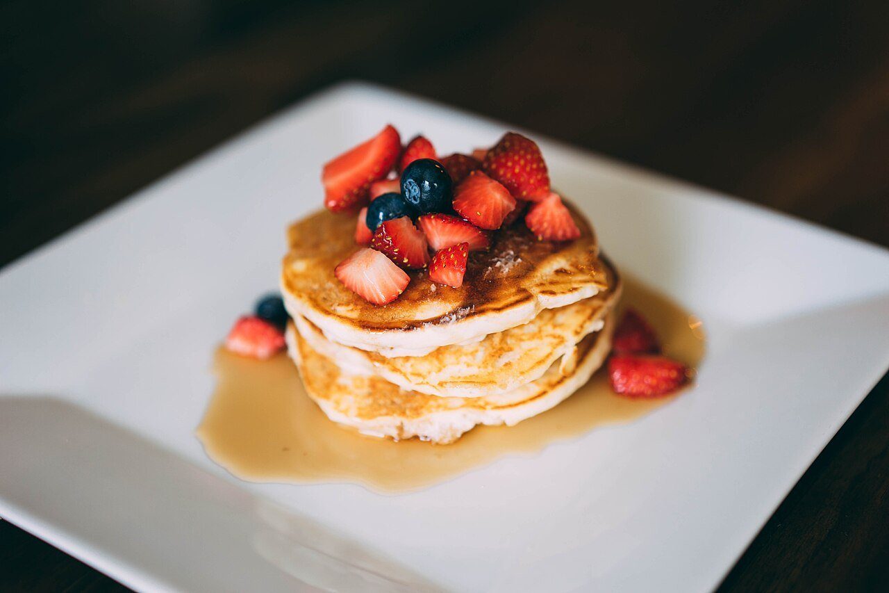 A stack of pancakes with berries